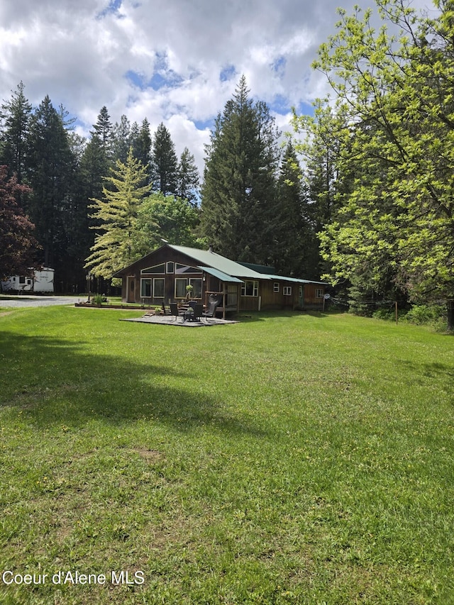 295 A St, Sandpoint, ID 83864 - view of grassy yard featuring a wooded view