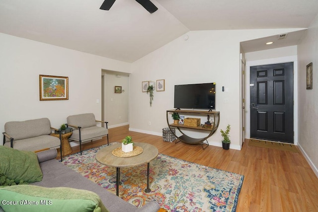 living room with vaulted ceiling, baseboards, wood finished floors, and ceiling fan