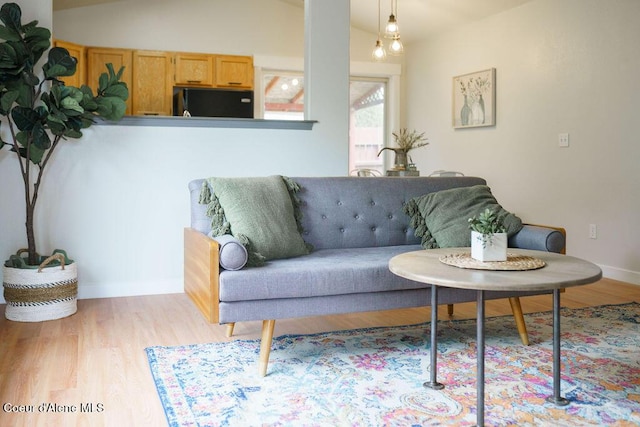 living area with wood finished floors and baseboards