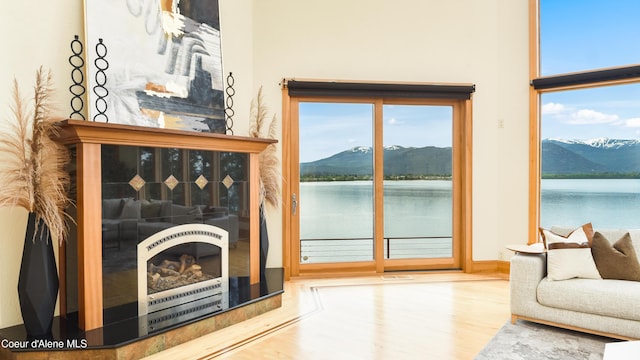 3361 Bottle Bay Rd, Sagle, ID 83860 - living room with wood finished floors, a water and mountain view, and baseboards