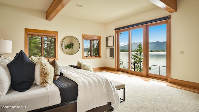 3361 Bottle Bay Rd, Sagle, ID 83860 - carpeted bedroom featuring beam ceiling, access to exterior, baseboards, and a water view