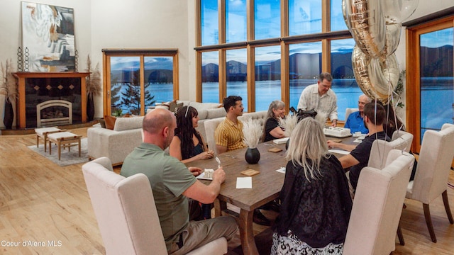 3361 Bottle Bay Rd, Sagle, ID 83860 - dining space featuring wood finished floors, a water view, and plenty of natural light