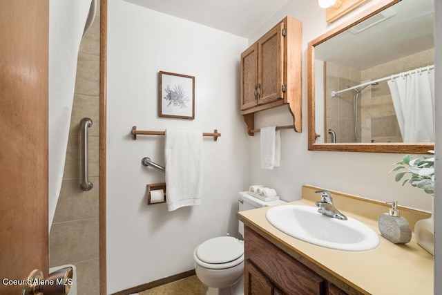 bathroom featuring tiled shower, vanity, and toilet