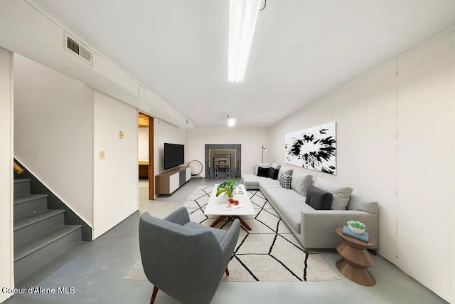 living room with concrete flooring and stairway