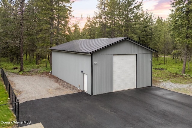 990 Goldfinch Ln, Spirit Lake, ID 83869 - outdoor structure at dusk featuring an outbuilding and fence