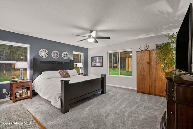 990 Goldfinch Ln, Spirit Lake, ID 83869 - carpeted bedroom with baseboards, a textured ceiling, and ceiling fan