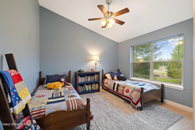 22385 N Ranch View Dr, Rathdrum, ID 83858 - bedroom featuring vaulted ceiling, wood finished floors, baseboards, and ceiling fan