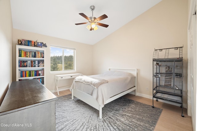22385 N Ranch View Dr, Rathdrum, ID 83858 - bedroom featuring lofted ceiling, wood finished floors, baseboards, and a ceiling fan