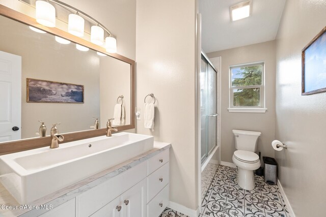 22385 N Ranch View Dr, Rathdrum, ID 83858 - full bath with toilet, baseboards, vanity, and tile patterned flooring
