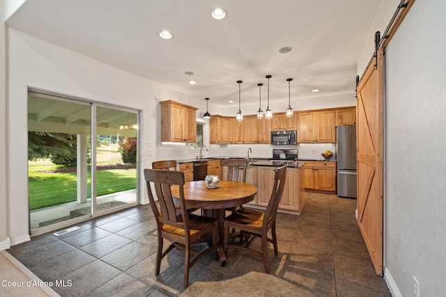 22385 N Ranch View Dr, Rathdrum, ID 83858 - dining room with a barn door, recessed lighting, and baseboards