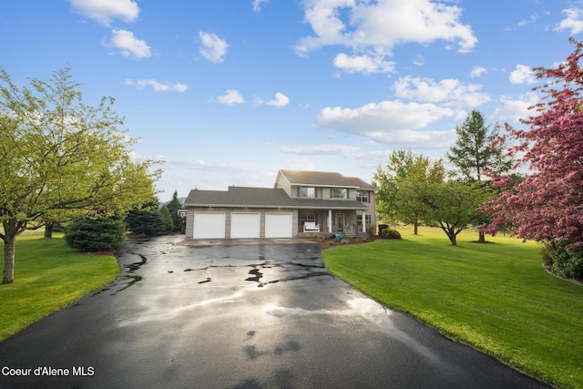 22385 N Ranch View Dr, Rathdrum, ID 83858 - view of front of house with a garage, driveway, a front lawn, and a porch