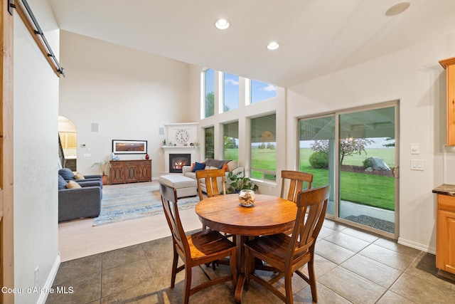 22385 N Ranch View Dr, Rathdrum, ID 83858 - dining area with dark tile patterned floors, a lit fireplace, plenty of natural light, recessed lighting, and baseboards