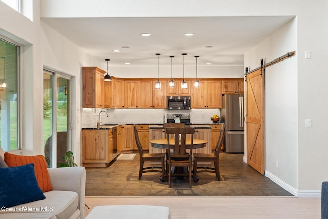 22385 N Ranch View Dr, Rathdrum, ID 83858 - kitchen with appliances with stainless steel finishes, a sink, tasteful backsplash, recessed lighting, and dark countertops