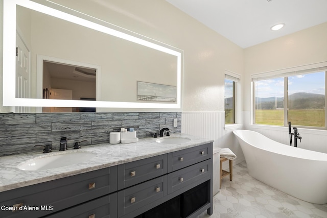 22385 N Ranch View Dr, Rathdrum, ID 83858 - full bathroom featuring wainscoting, a freestanding bath, double vanity, and tile patterned floors