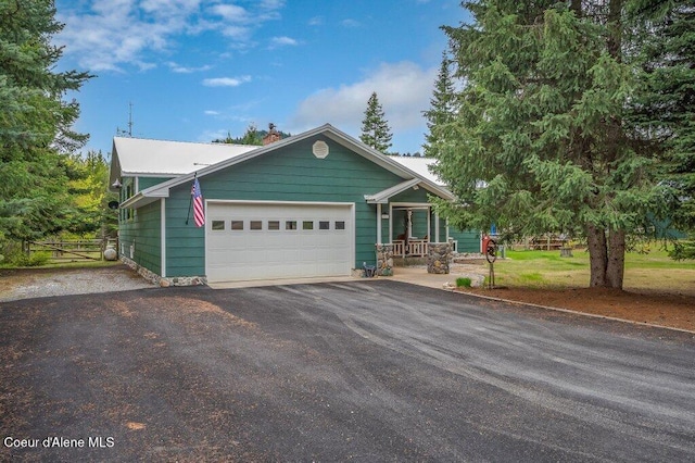 521 Shady Pines Loop, Priest Lake, ID 83856 - ranch-style home featuring a garage, asphalt driveway, a chimney, and covered porch