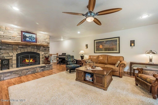 521 Shady Pines Loop, Priest Lake, ID 83856 - living room featuring ceiling fan, wood finished floors, a stone fireplace, and recessed lighting