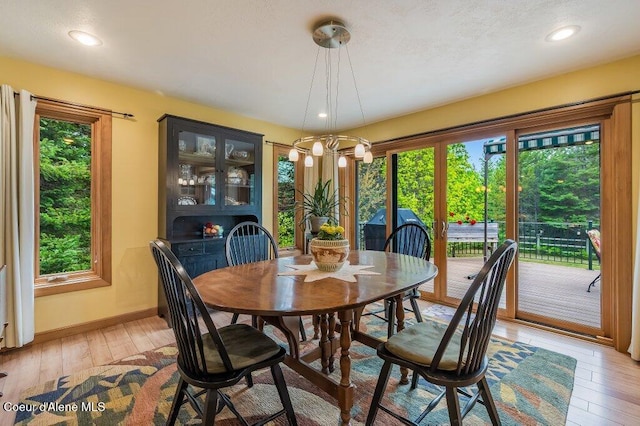 521 Shady Pines Loop, Priest Lake, ID 83856 - dining area with light wood-style flooring, baseboards, a chandelier, and recessed lighting