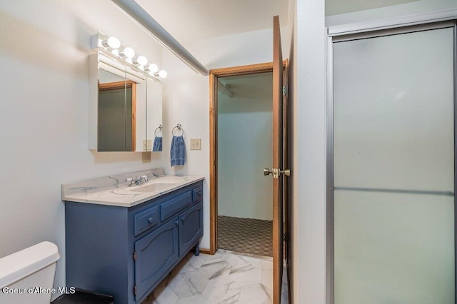 521 Shady Pines Loop, Priest Lake, ID 83856 - bathroom with marble finish flooring, toilet, vanity, and a shower
