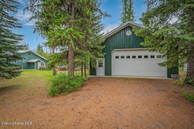 521 Shady Pines Loop, Priest Lake, ID 83856 - view of front facade featuring a garage and board and batten siding