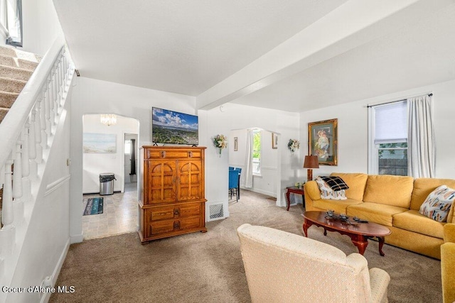 1315 N 7th St, Coeur Dalene, ID 83814 - carpeted living area with baseboards, stairway, and a chandelier