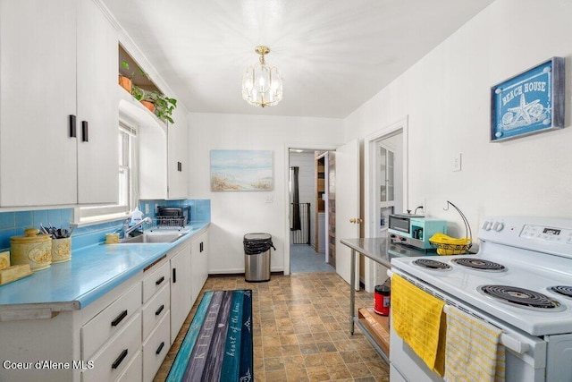 1315 N 7th St, Coeur Dalene, ID 83814 - kitchen featuring white range with electric cooktop, a sink, white cabinetry, a chandelier, and light countertops