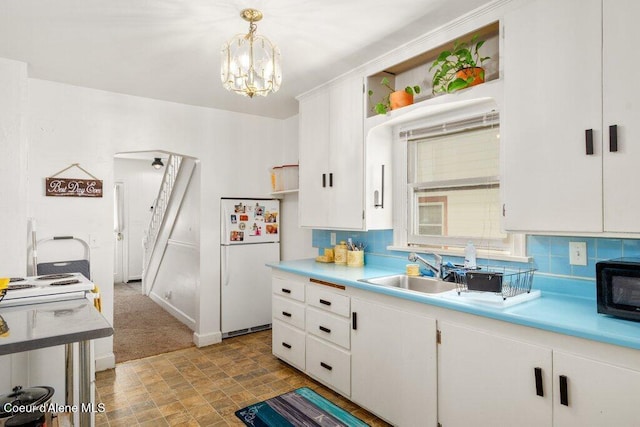 1315 N 7th St, Coeur Dalene, ID 83814 - kitchen featuring freestanding refrigerator, a sink, white cabinets, and light countertops