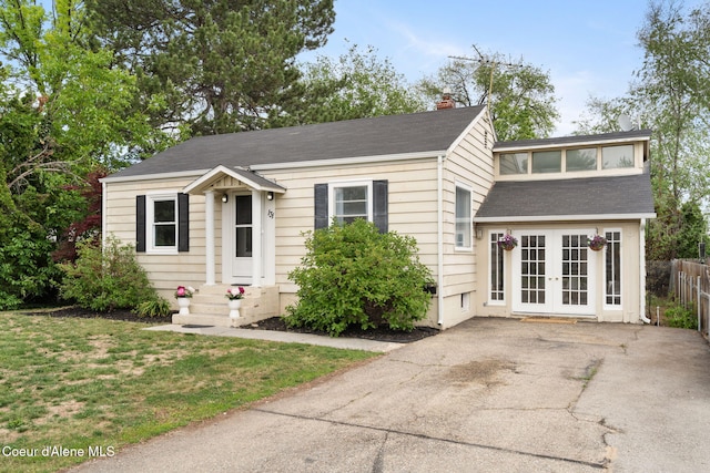 131 Ord Blvd, Nampa, ID 83686 - view of front of house featuring french doors, a chimney, and a shingled roof