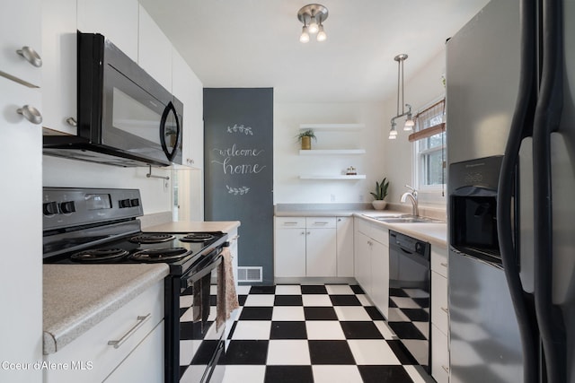 131 Ord Blvd, Nampa, ID 83686 - kitchen featuring black appliances, tile patterned floors, a sink, open shelves, and white cabinetry