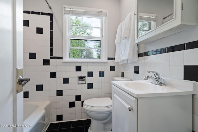 131 Ord Blvd, Nampa, ID 83686 - bathroom featuring tile walls, tile patterned flooring, toilet, a tub to relax in, and vanity
