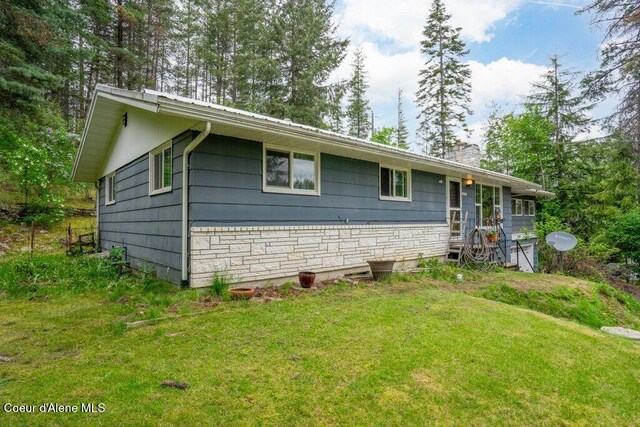 204 Sunrise Dr, Pinehurst, ID 83850 - ranch-style house with a chimney, a front lawn, and stone siding