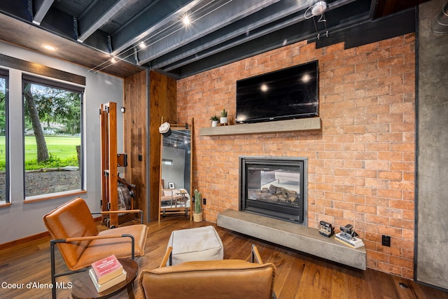 11679 N Avondale Loop, Hayden, ID 83835 - living area with hardwood / wood-style flooring, a brick fireplace, baseboards, and beam ceiling