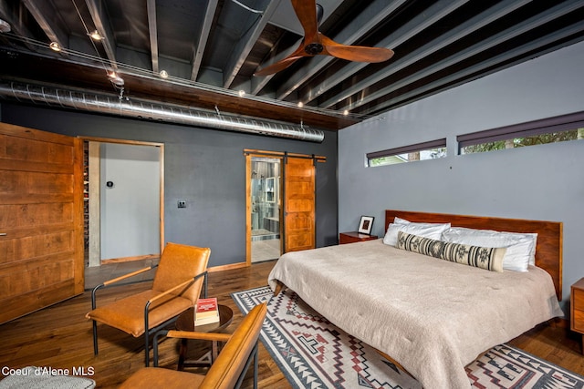 11679 N Avondale Loop, Hayden, ID 83835 - bedroom with a barn door and wood finished floors