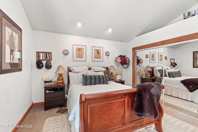 bedroom featuring light colored carpet, vaulted ceiling, and baseboards