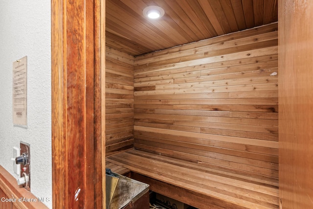 sauna / steam room with wooden walls and recessed lighting