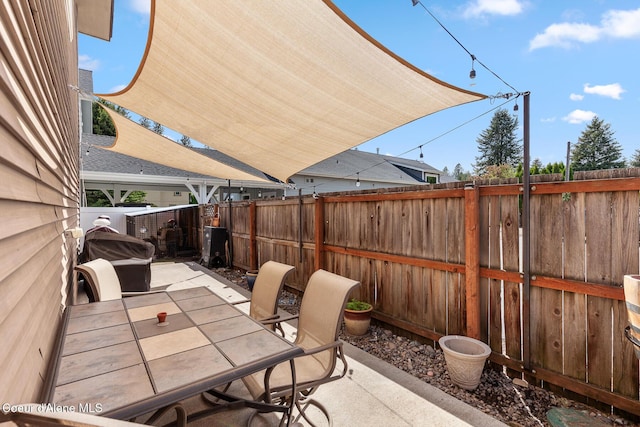 view of patio featuring outdoor dining area and a fenced backyard