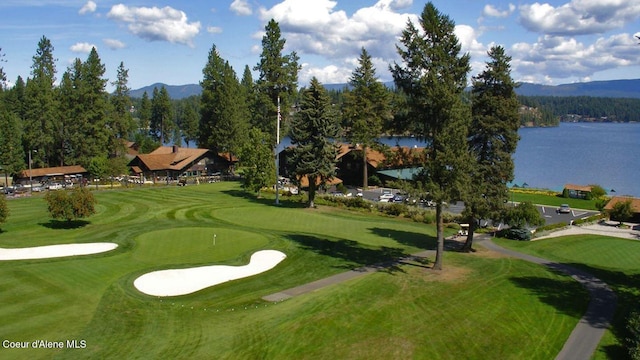 view of property's community with a water and mountain view and golf course view