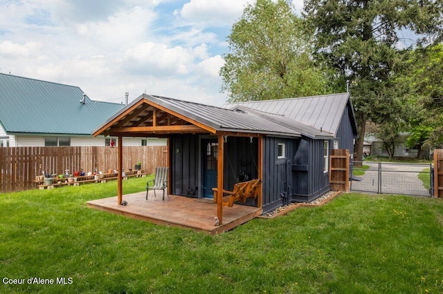 707 Washington Ave, Sandpoint, ID 83864 - back of house featuring a gate, metal roof, board and batten siding, and an outbuilding