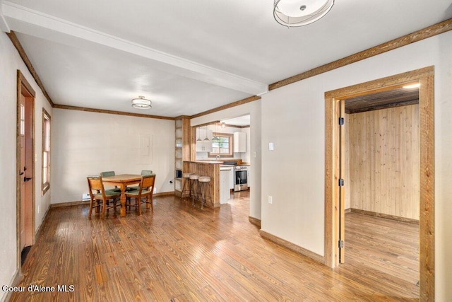 707 Washington Ave, Sandpoint, ID 83864 - dining room featuring wood finished floors, crown molding, and baseboards