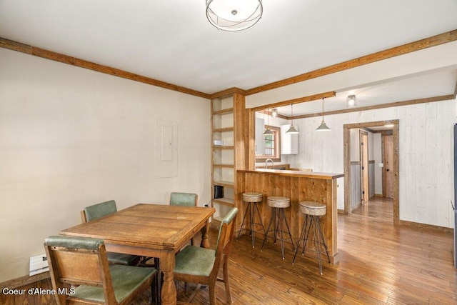 707 Washington Ave, Sandpoint, ID 83864 - dining area with hardwood / wood-style flooring, crown molding, and baseboards