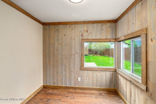 707 Washington Ave, Sandpoint, ID 83864 - empty room with plenty of natural light, wood finished floors, baseboards, and wooden walls