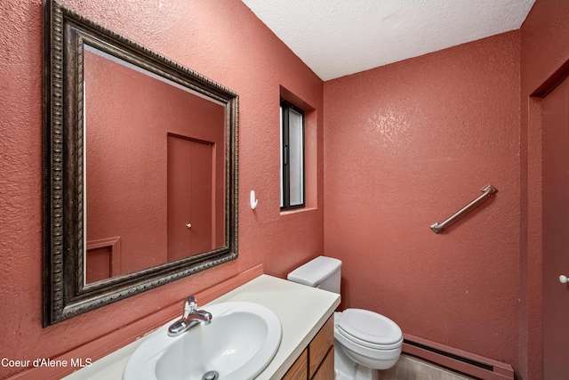 1706 E Thomas Ln, Coeur Dalene, ID 83815 - bathroom with a baseboard radiator, a textured wall, vanity, toilet, and a textured ceiling