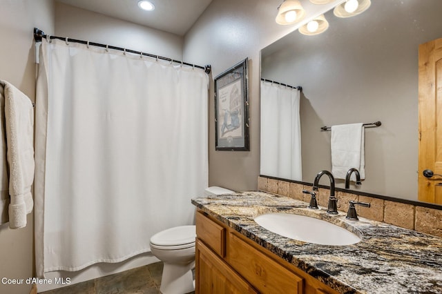 full bathroom featuring toilet, vanity, and a shower with shower curtain
