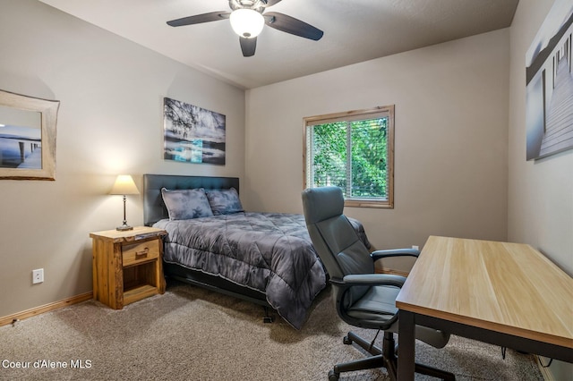 carpeted bedroom with baseboards, an office area, and a ceiling fan