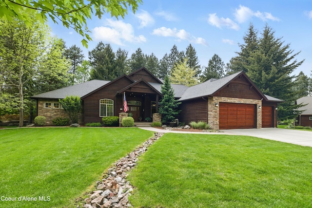 view of front of property with stone siding, concrete driveway, a garage, and a front yard