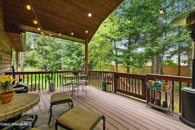 wooden terrace featuring fence and outdoor dining space