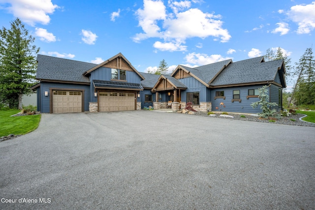 1230 E Amulet Cir, Rathdrum, ID 83858 - view of front of home with board and batten siding, a shingled roof, stone siding, and an attached garage