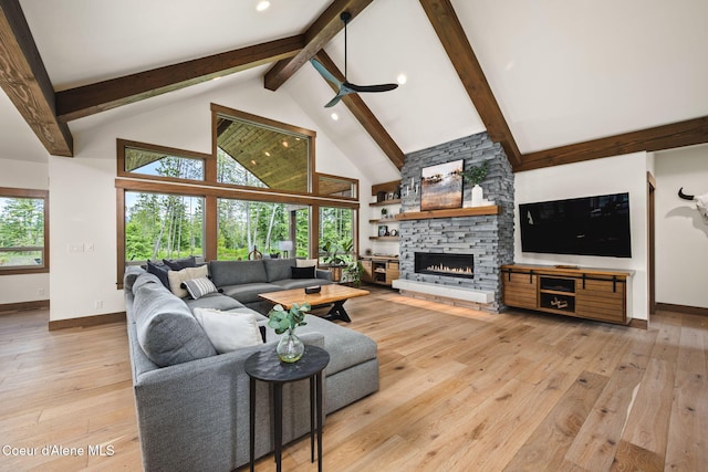 1230 E Amulet Cir, Rathdrum, ID 83858 - living area featuring beamed ceiling, light wood-style flooring, baseboards, high vaulted ceiling, and a stone fireplace