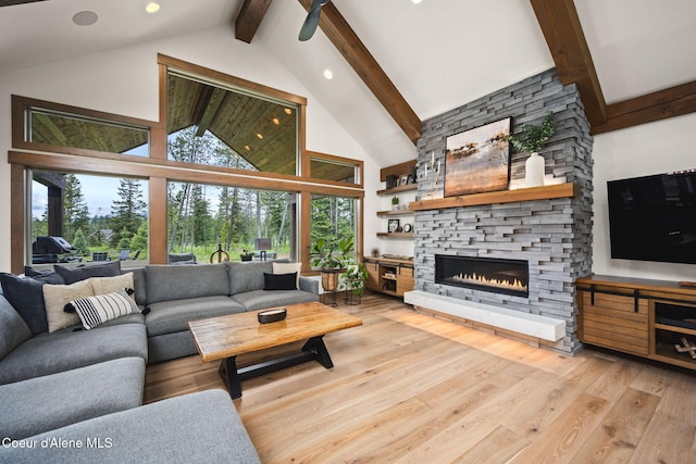 1230 E Amulet Cir, Rathdrum, ID 83858 - living room with beam ceiling, high vaulted ceiling, light wood-style floors, a fireplace, and a ceiling fan