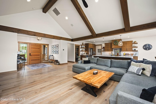 1230 E Amulet Cir, Rathdrum, ID 83858 - living area featuring recessed lighting, beam ceiling, high vaulted ceiling, light wood-style flooring, and baseboards
