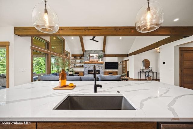 1230 E Amulet Cir, Rathdrum, ID 83858 - kitchen featuring a stone fireplace, open floor plan, a sink, pendant lighting, and recessed lighting